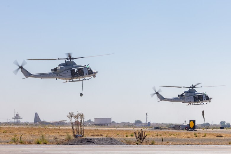 Two U.S. Marine Corps UH-1Y Venom assigned to 3rd Marine Aircraft Wing, I Marine Expeditionary Force, fly above the flight line during the Marine Air-Ground Task Force demonstration of the 2024 Marine Corps Air Station Miramar Airshow in San Diego, Sept. 26, 2024. The MAGTF Demo displays the coordinated use of close-air support, armor, artillery and infantry forces and provides a visual representation of how the Marine Corps operates. America's Airshow 2024 is a unique and incredible opportunity to witness Marine and joint aviation capabilities, civilian performers, and the world-famous Blue Angels; to interact first-hand with Marines, other service members, and first responders; and to see first-hand the innovative spirit of the Marine Corps through emerging technologies and forward-thinking. (U.S. Marine Corps photo by Lance Cpl. Jennifer Sanchez)