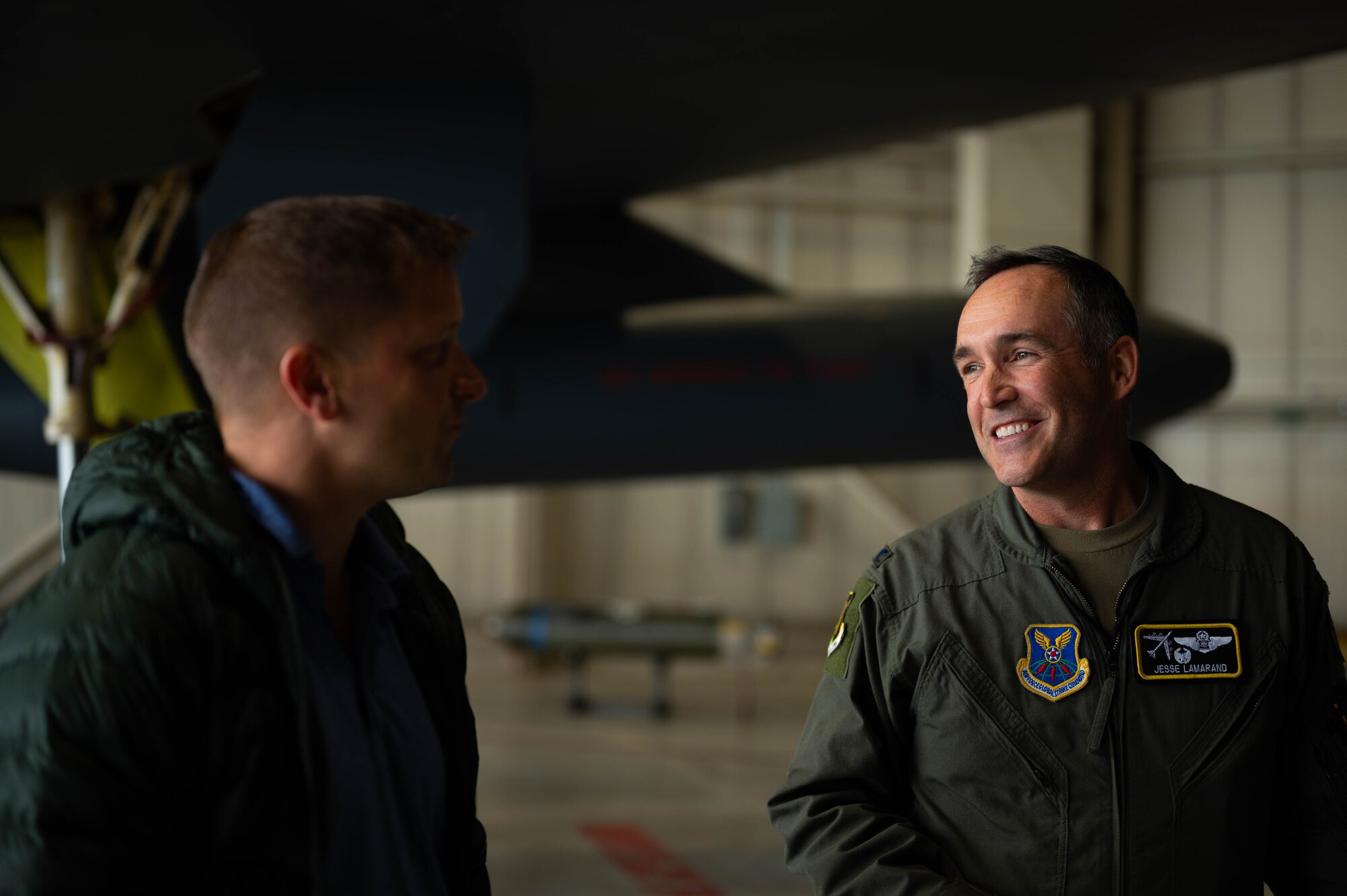 U.S. Air Force Col. Jesse Lamarand, 5th Bomb Wing Commander (right), converses with a member of the Congressional Staff Delegation (STAFFDEL) during a B-52H Stratofortress static tour at Minot Air Force Base, North Dakota, Oct. 2, 2024. The visit provided an opportunity for Minot AFB to showcase the strategic mission to the STAFFDELs. (U.S. Air Force photo by Airman 1st Class Luis Gomez)
