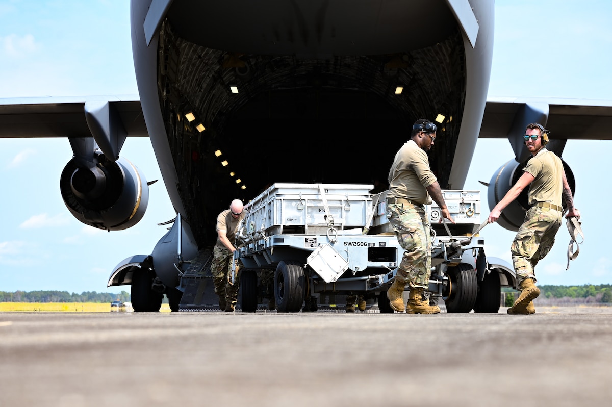 Airmen unloading munitions from a C-17.