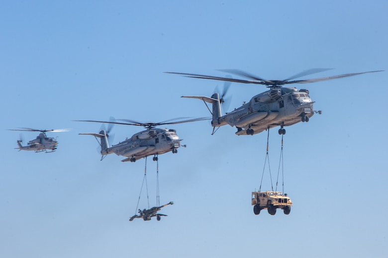 U.S. Marine Corps CH-53E Super Stallions with Marine Aircraft Group 16, 3rd Marine Aircraft Wing, I Marine Expeditionary Force, lift a Joint Light Tactical Vehicle and M777 155 mm towed howitzer during the Marine Air-Ground Task Force demonstration of the 2024 Marine Corps Air Station Miramar Airshow in San Diego, Sept. 28, 2024. The MAGTF Demo displays the coordinated use of close-air support, armor, artillery and infantry forces and provides a visual representation of how the Marine Corps operates. America's Airshow 2024 is a unique and incredible opportunity to witness Marine and joint aviation capabilities, civilian performers, and the world-famous Blue-Angels; to interact first-hand with Marines, other service members, and first responders; and to see first-hand the innovative spirit of the Marine Corps through emerging technologies and forward-thinking. (U.S. Marine Corps photo by Cpl. Arthur W. Shores)