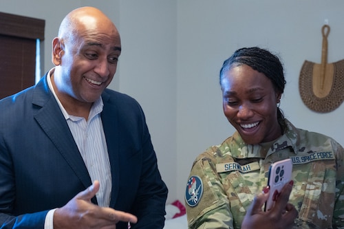 Dr. Ravi Chaudhary video chats with Spc. Serwaah's sister during a tour of the unaccompanied housing tour.