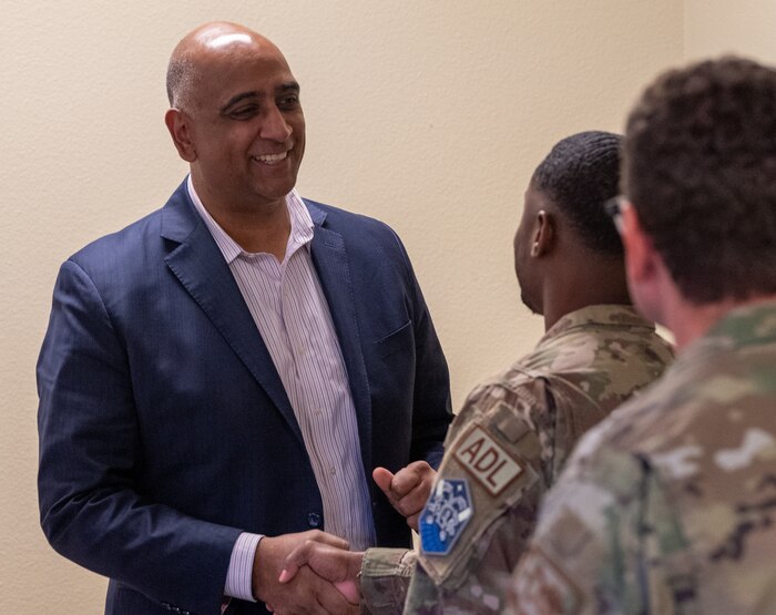 Dr. Ravi Chaudhary greets privatized housing residents before they begin their roundtable discussion