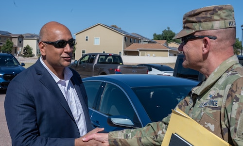 Dr. Ravi Chaudhary shakes hand with Col. Klock as they greet each other at the beginning of the tour.