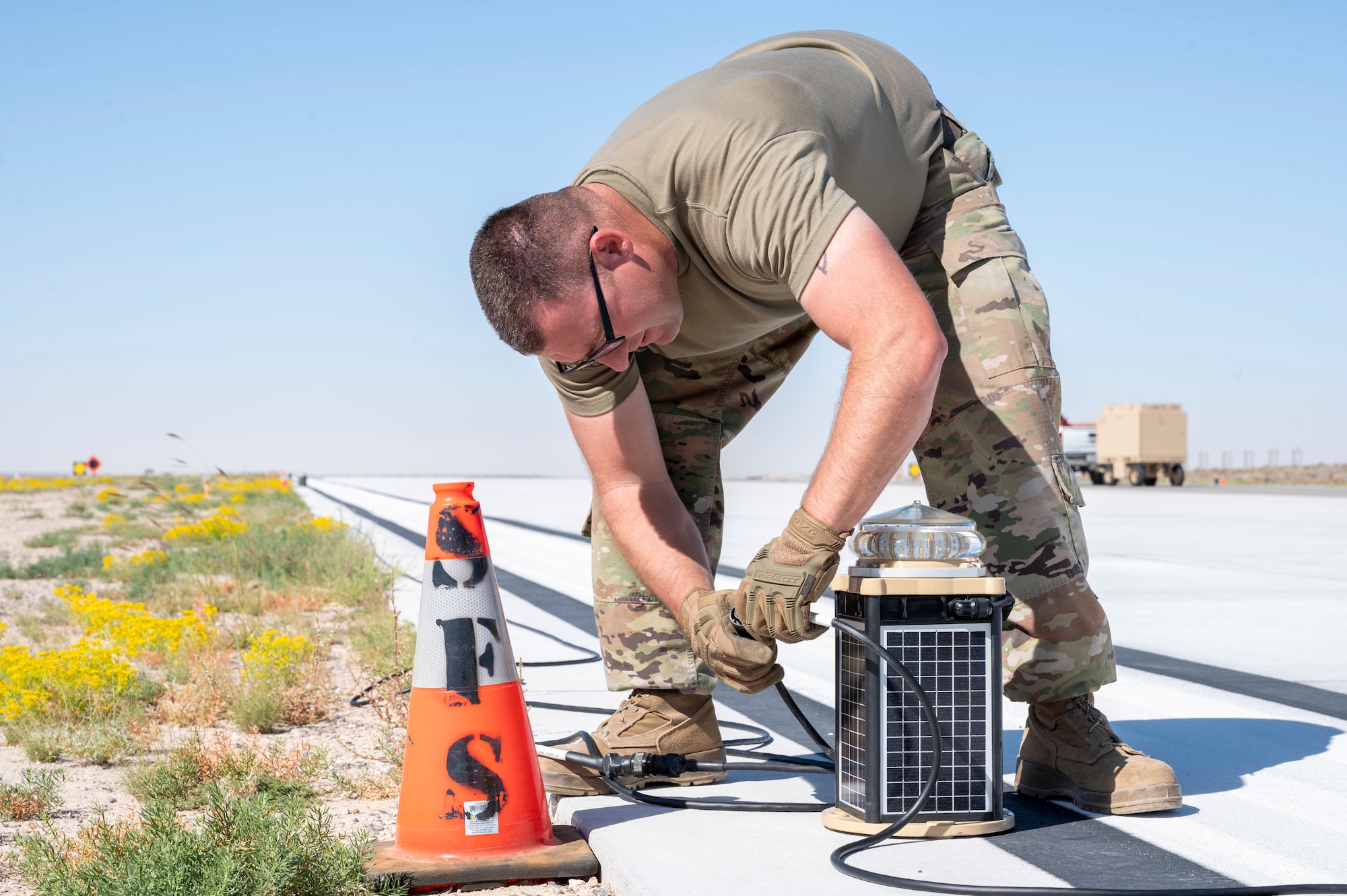U.S. Air Force Tech. Sgt. Brianna Gonzales, 635th Materiel Maintenance Squadron regional training noncommissioned officer in charge, unravels a cord to power Expeditionary Airfield Lighting Systems-C during Operation TRAILBLAZER at Holloman Air Force Base, New Mexico, Oct. 1, 2024.