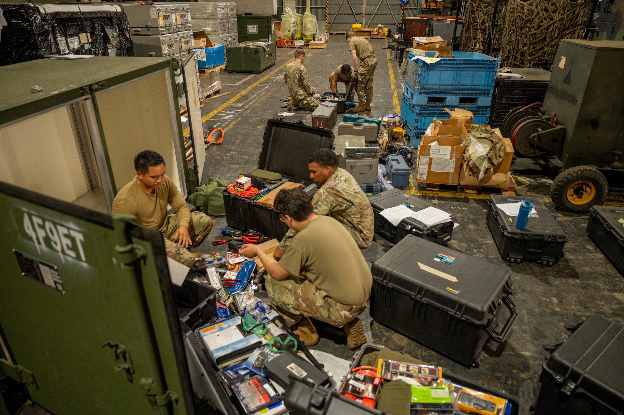 Airmen sort through tools.