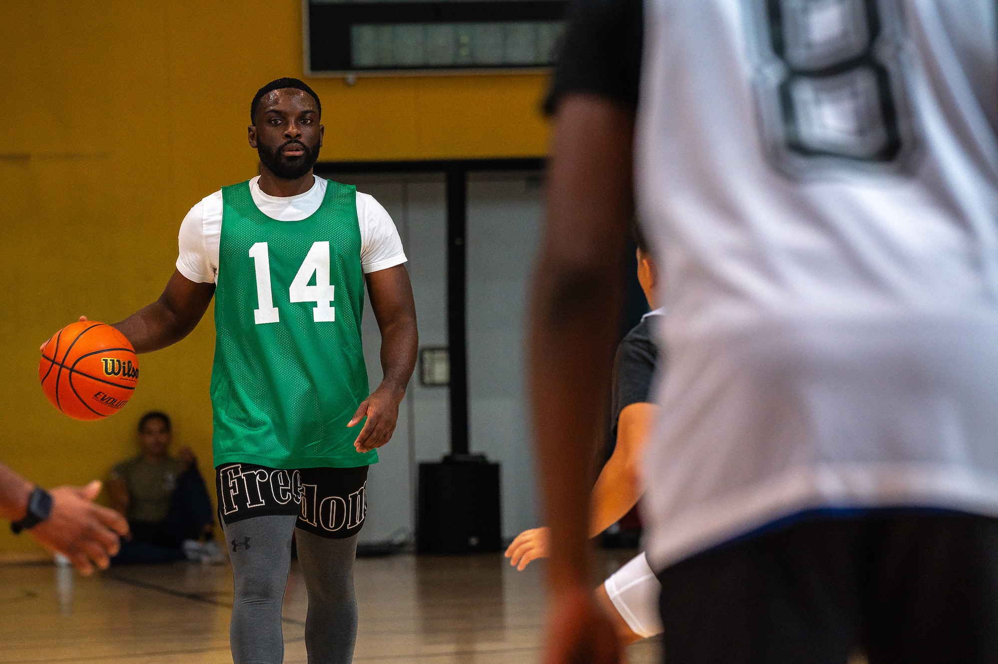 A man dribbles a basketball