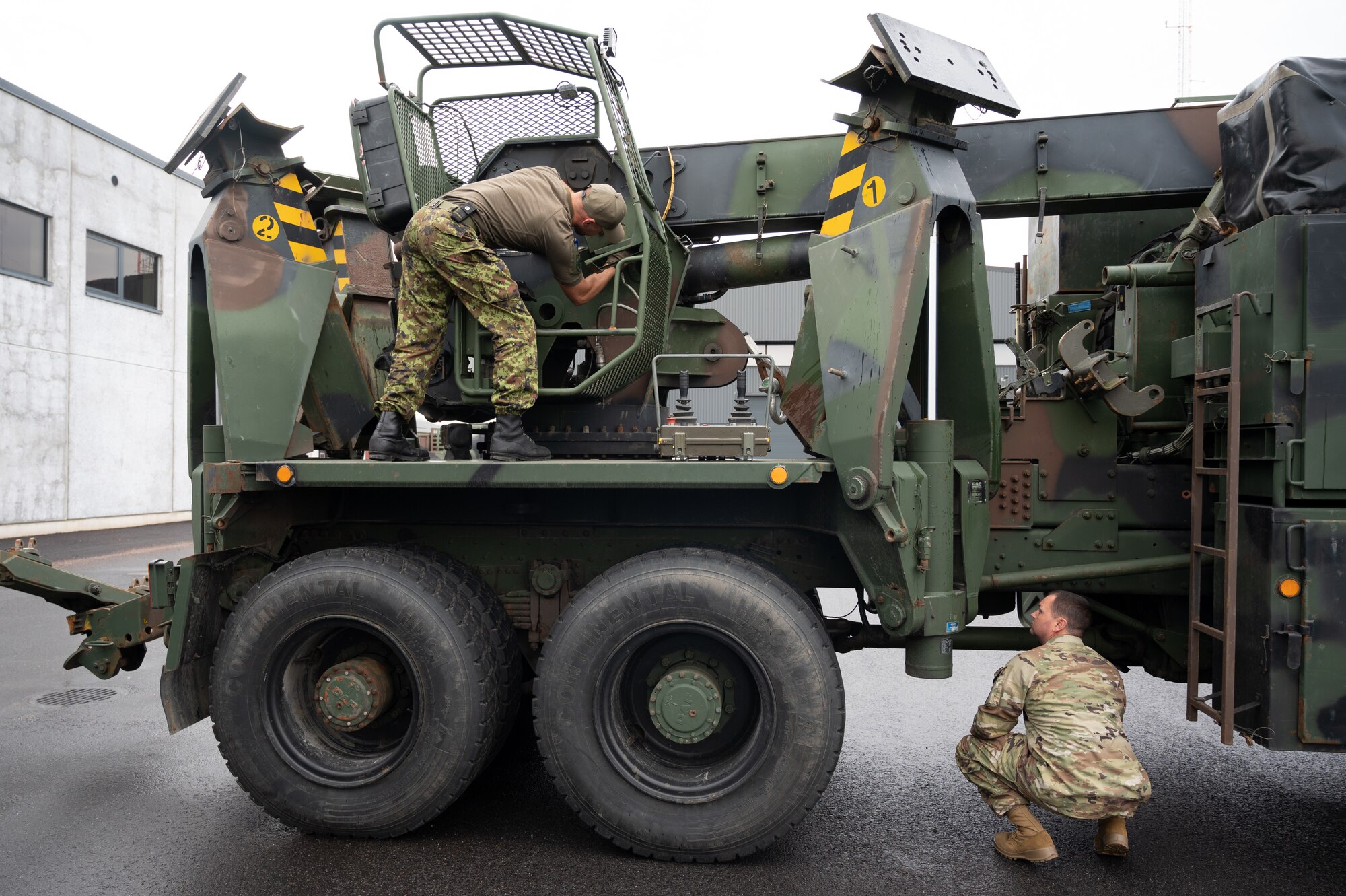 U.S. Air Force Staff Sgt. Jonathan Bandy, 175th Logistics Readiness Squadron vehicle maintenance craftsman, partners with an Estonian Defense League counterpart to inspect a DAF wrecker during Operation Baltic Rhino, September 14, 2024, at the Eametsa military base, Parnu, Estonia.