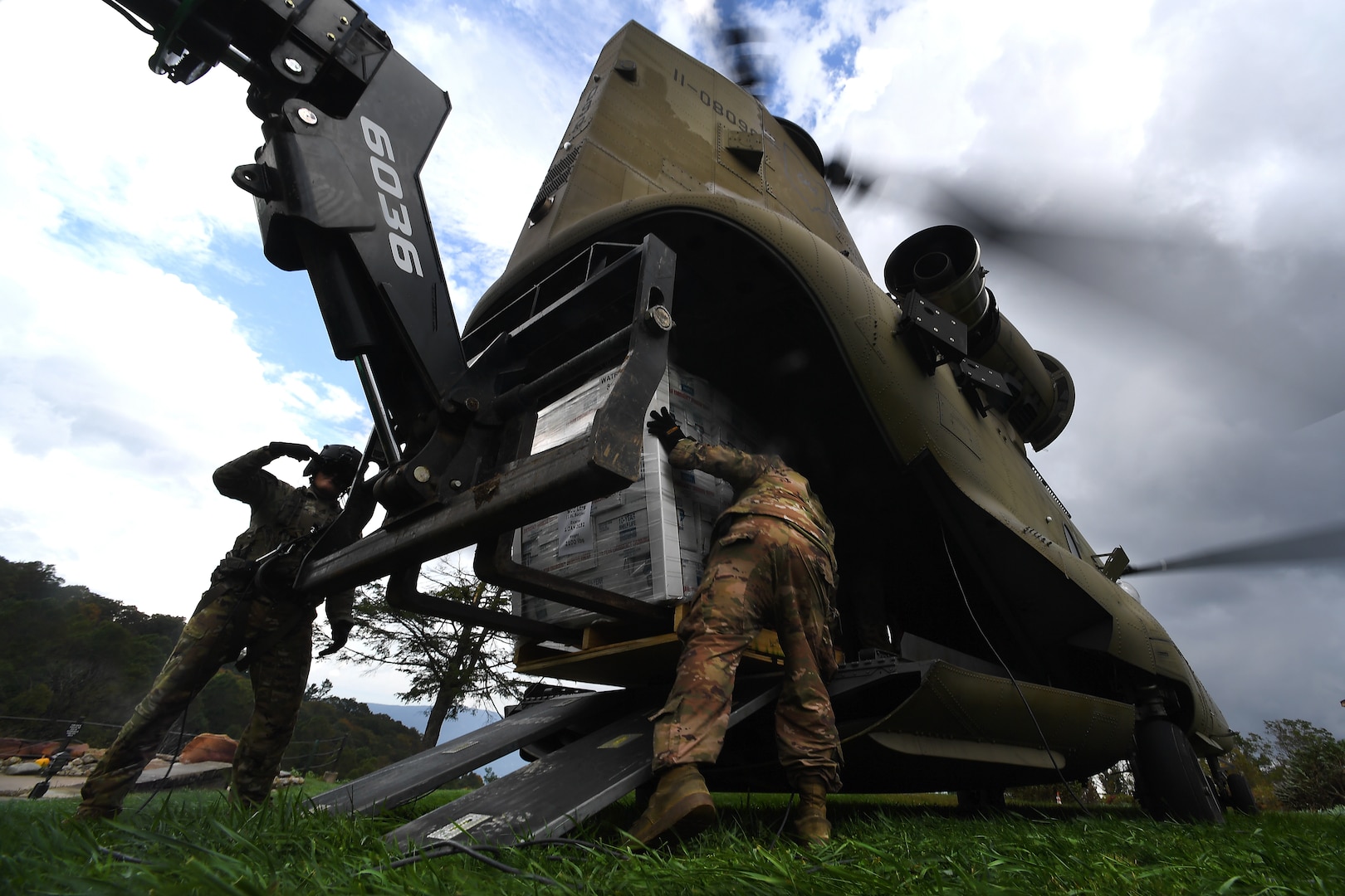 Soldiers with B Company, 2nd Battalion, 238th Aviation Regiment, Ohio Army National Guard, offload food, water and other supplies in a field in western North Carolina as part of response efforts in the aftermath of Hurricane Helene Oct. 4, 2024. National Guard units from multiple states have responded to areas impacted by the storm and have been taking part in food and water distribution, search and rescue, debris clearance and other tasks.