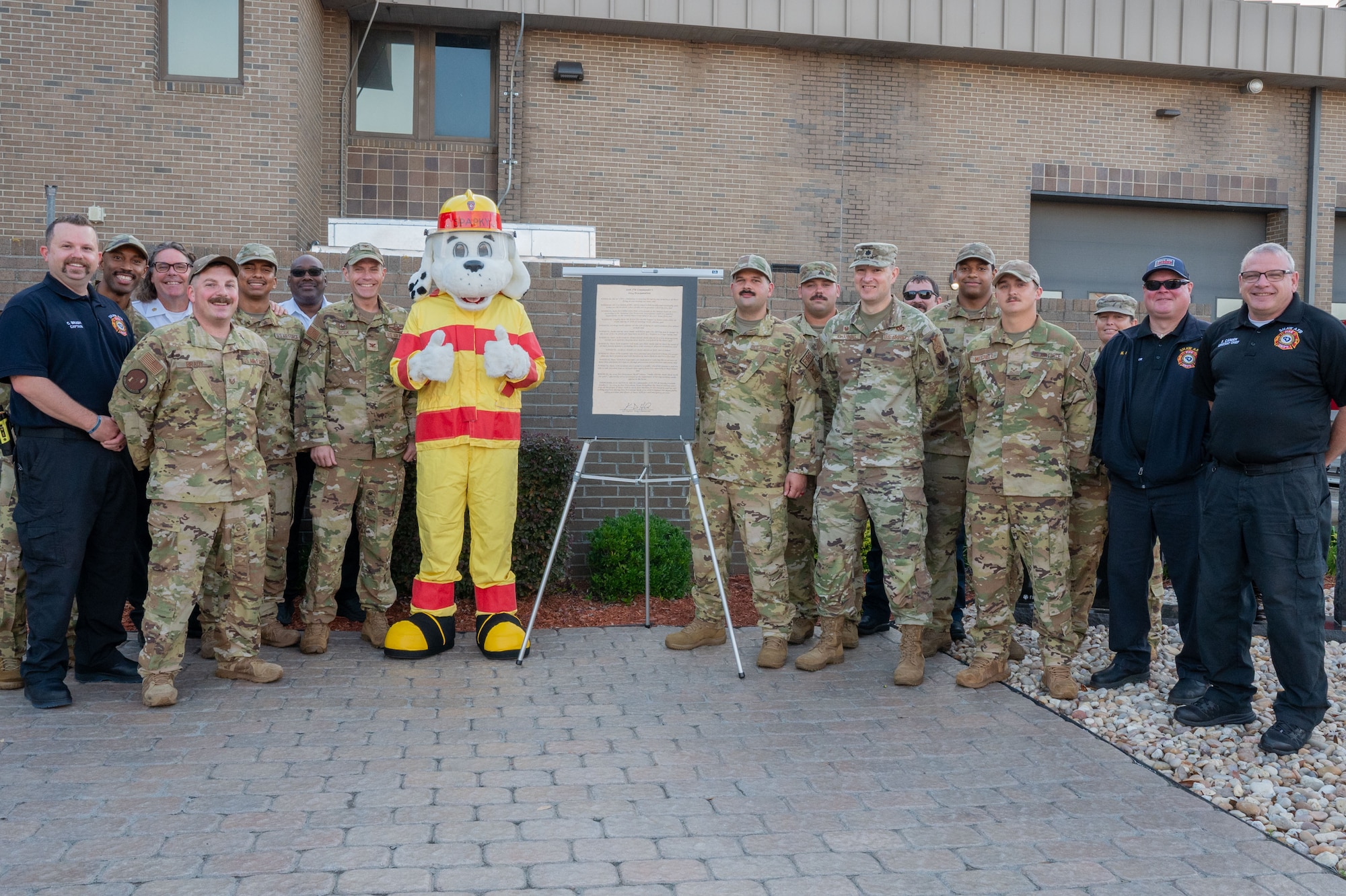 A group poses for a photo with the fire prevention proclamation.