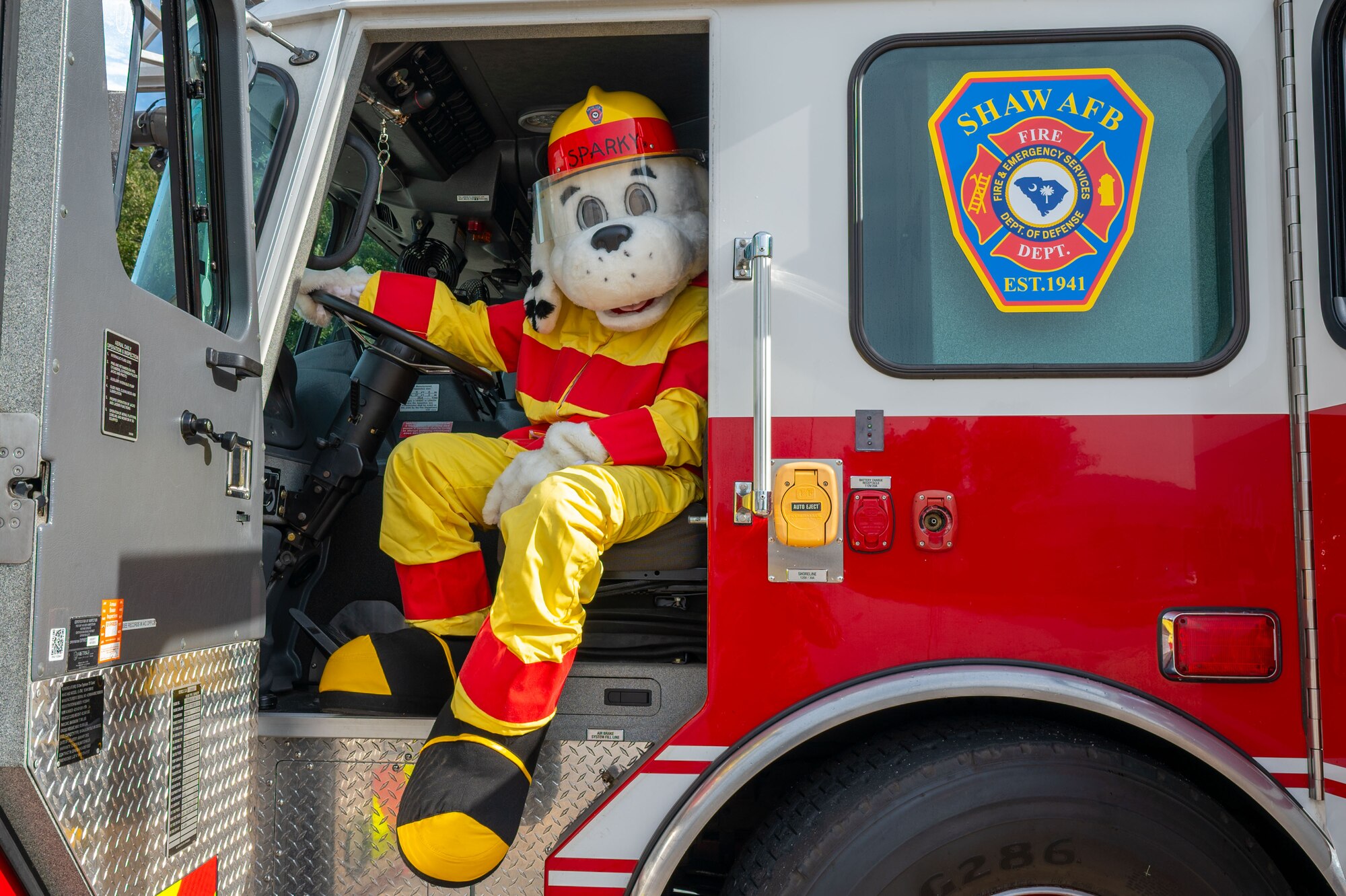 Sparky the Fire Dog poses for a photo.
