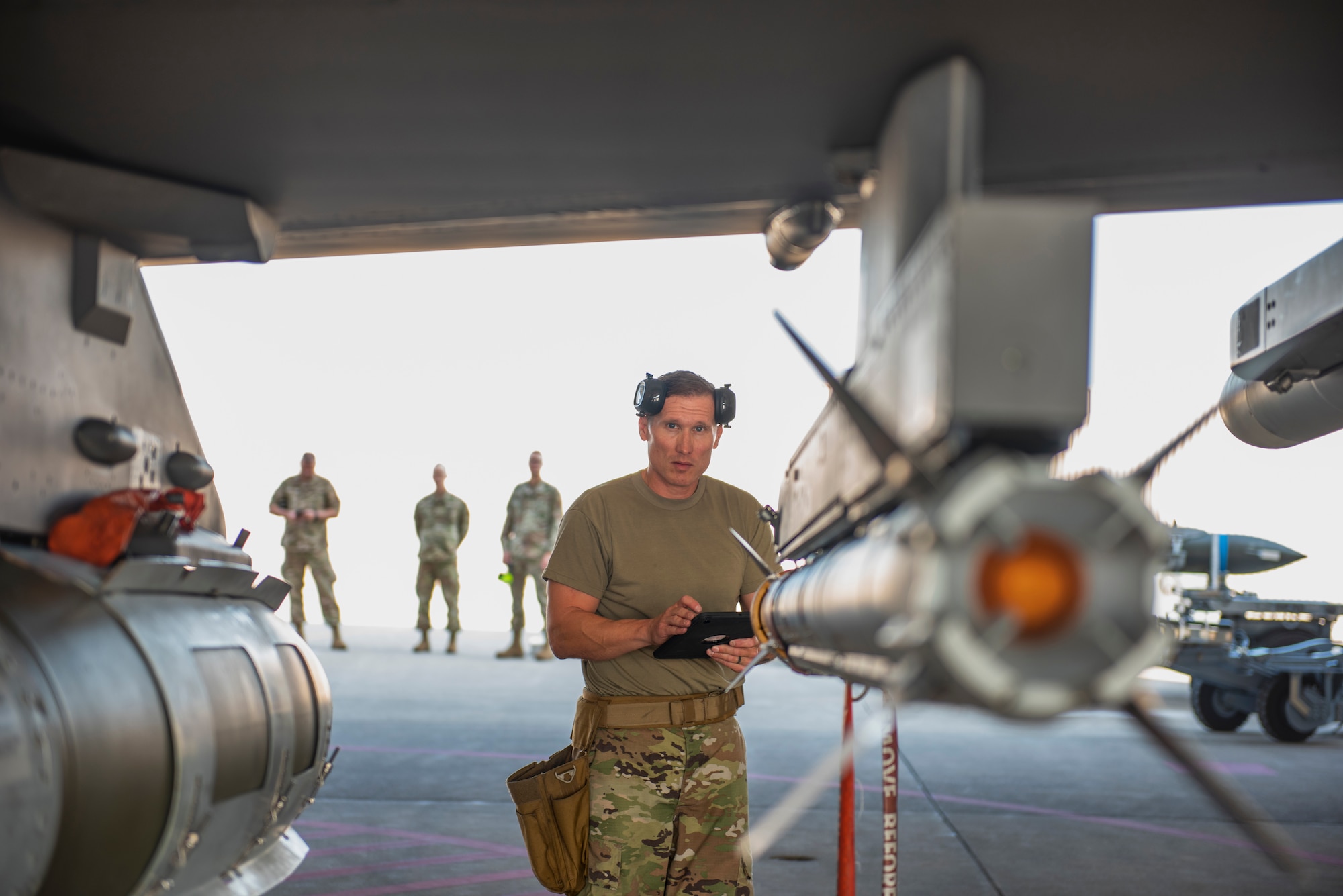Man inspects weapon.
