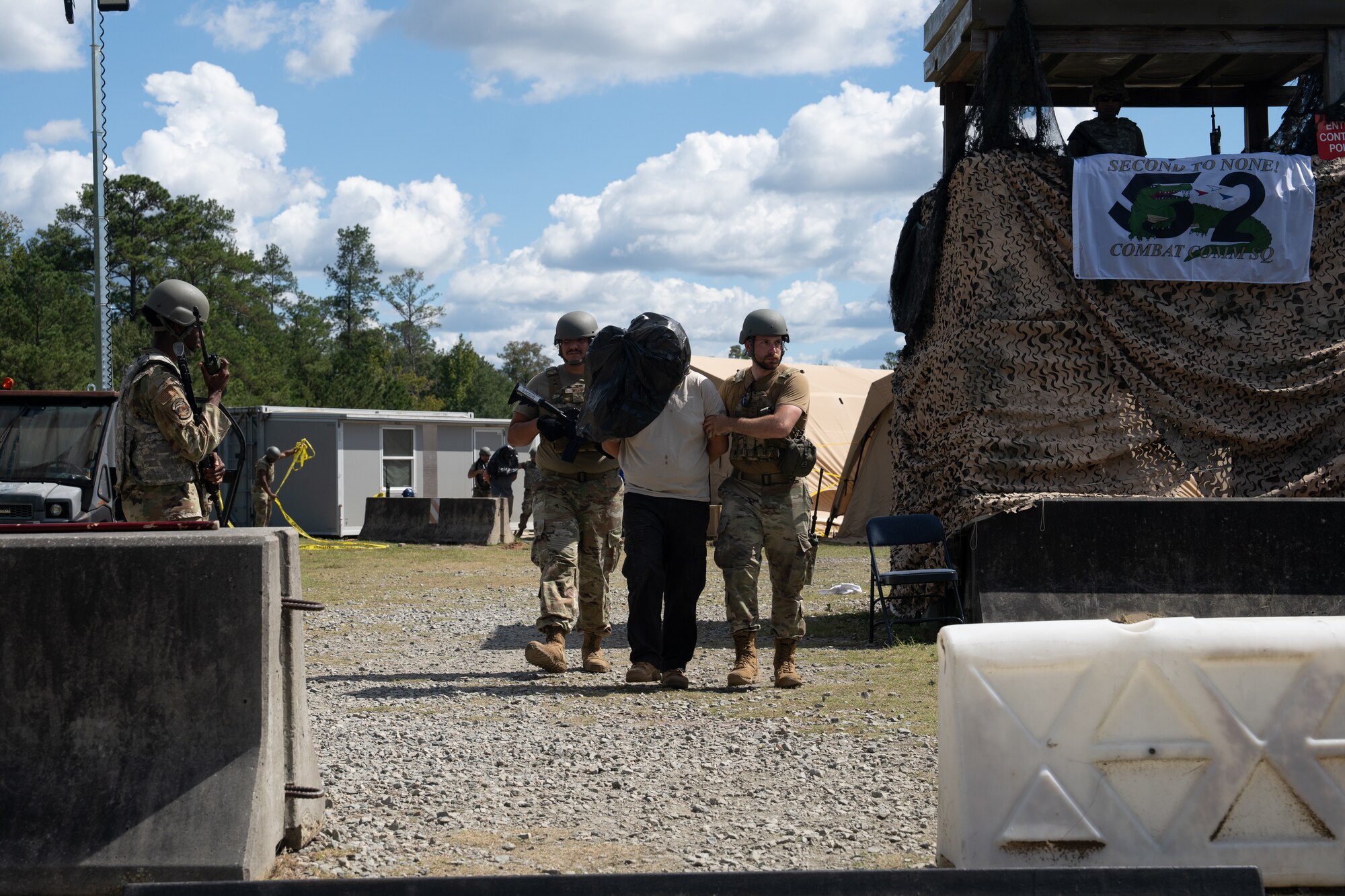 Airmen release a hostage after a simulated base incursion
