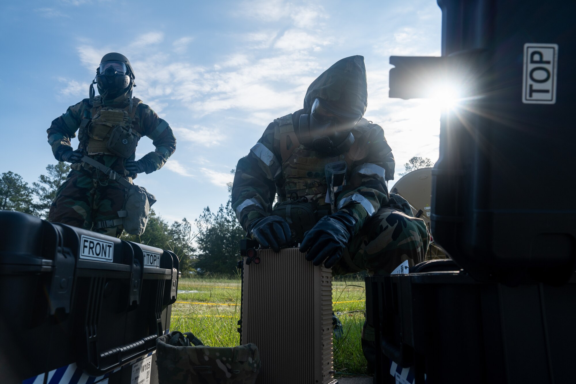 Two Airmen work on communications equipment
