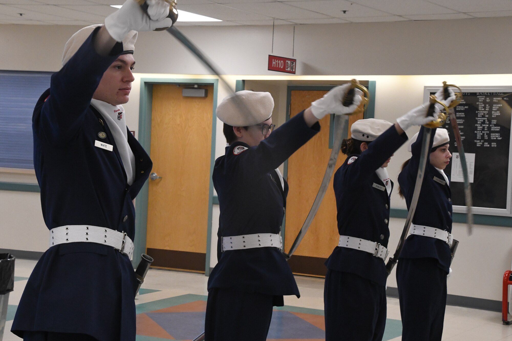 Ben Eielson High School Junior Reserve Officer Training Corps (JROTC) cadets present their swords, creating an archway entrance for Veterans to walk through during the Ben Eielson HS Veterans Day Breakfast, Nov. 10, 2022.