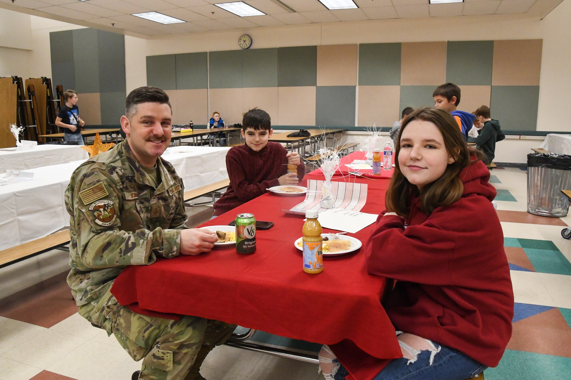 Master Sgt. Charles Jones, 354th Fighter Wing Munitions, attends the Ben Eielson High School Veterans Day Breakfast with his daughter Isadora Jones and his son Dorian Jones, Eielson Air Force Base, Nov. 10, 2022