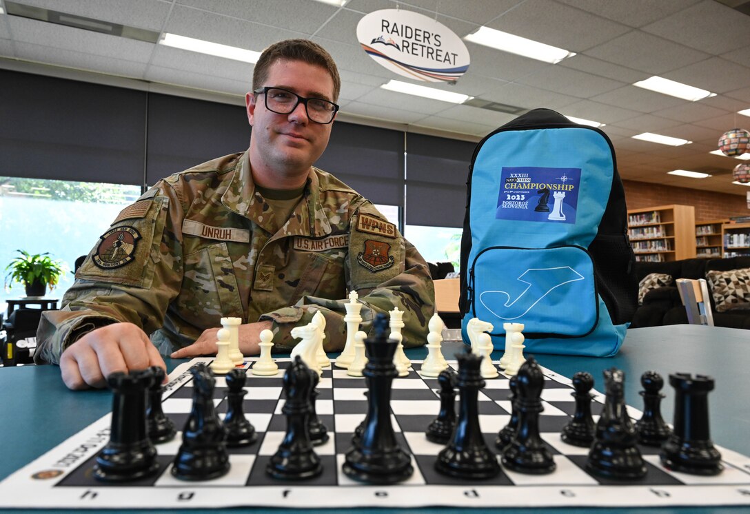 Airman poses with professional chess set.