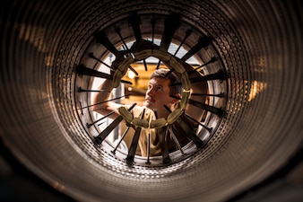 AD2 Tristan York performs maintenance on a F/A-18 jet engine aboard USS George Washington (CVN 73) in the Pacific Ocean.