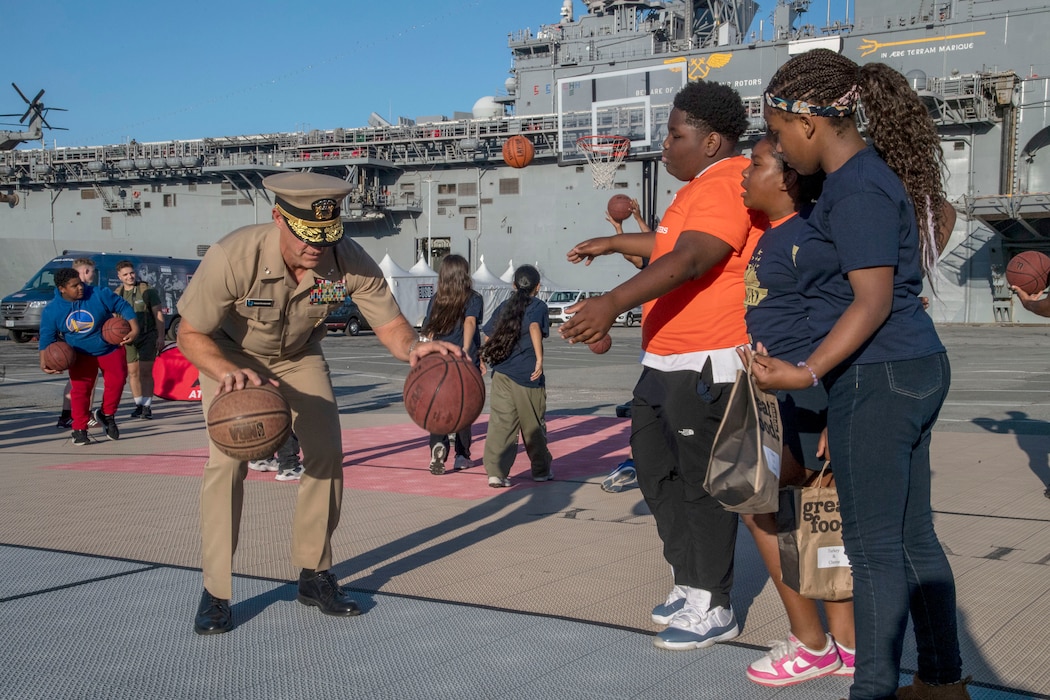 Rear Adm. Robert Nowakowski teaches his basketball skills during San Francisco Fleet Week 2024.