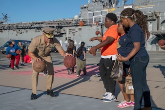 Rear Adm. Robert Nowakowski teaches his basketball skills during San Francisco Fleet Week 2024.