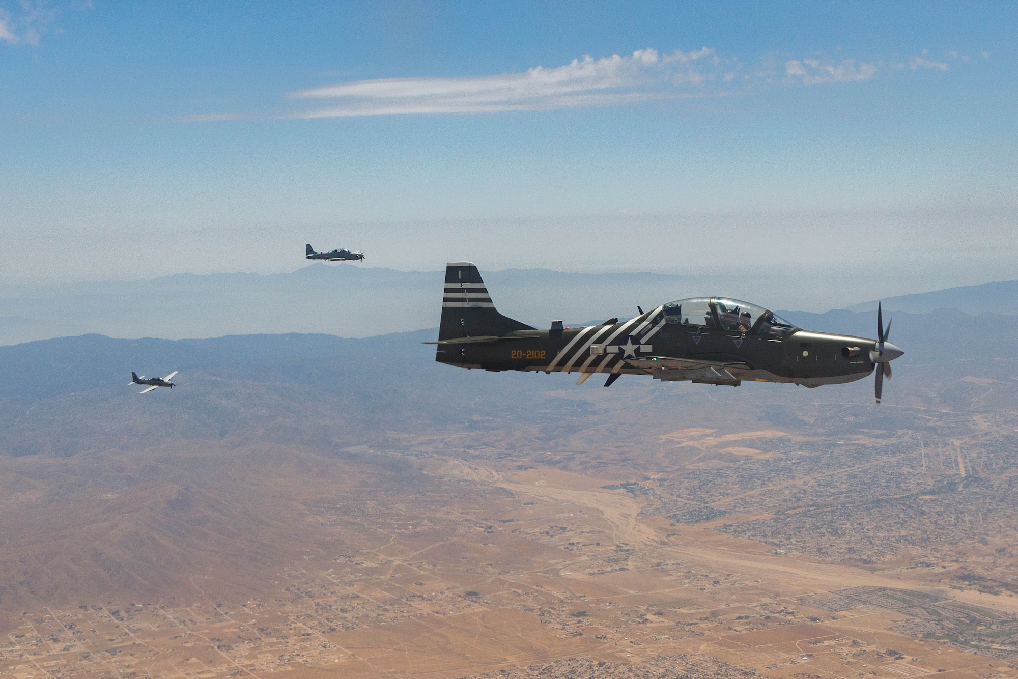 Three A-29 Super Tucanos conduct a ferry flight to Edwards Air Force Base, California, Aug. 18., where they will join a unique fleet at the U.S. Air Force Test Pilot School. (Air Force photo by Richard Gonzales)