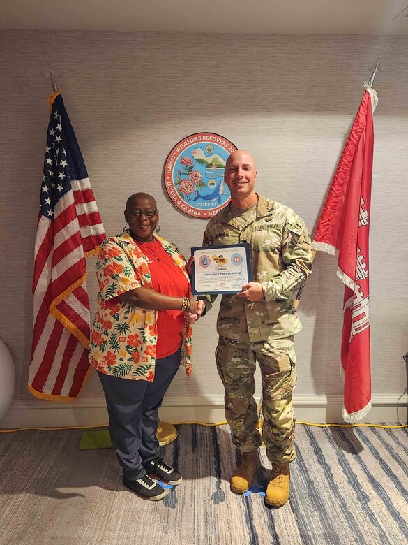 Mann giving a woman an award.