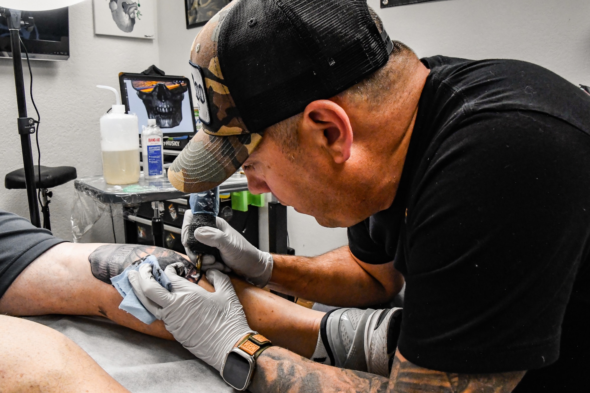 U.S. Air Force Chief Master Sgt. George Bender, 168th Aircraft Maintenance Squadron Chief, tattoos Brian Dianoski, Fairbanks resident, at  at a local tattoo shop in Fairbanks, Alaska, Sept. 27, 2023.