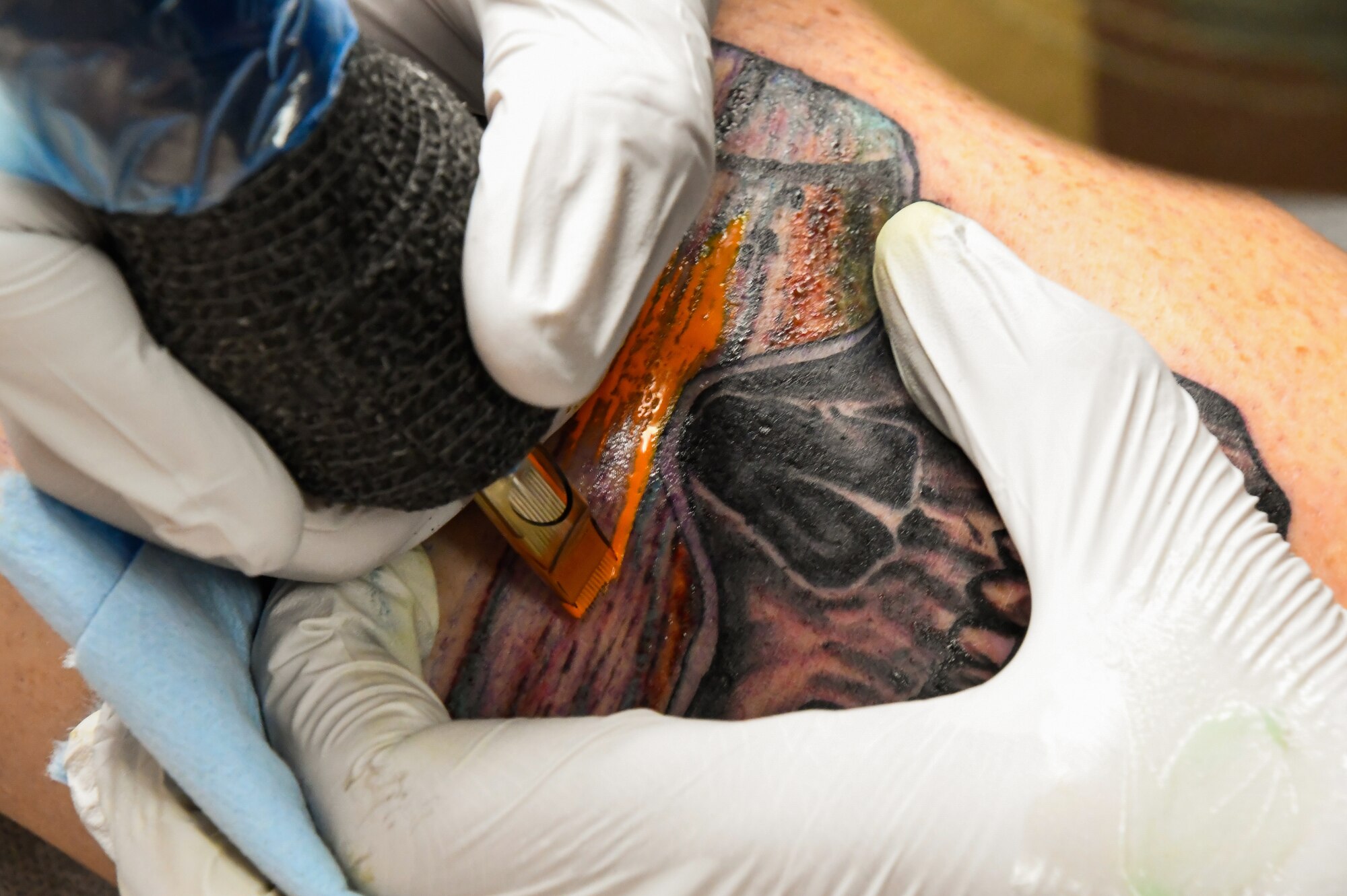 U.S. Air Force Chief Master Sgt. George Bender, 168th Aircraft Maintenance Squadron Chief, tattoos Brian Dianoski, Fairbanks resident,  at a local tattoo shop in Fairbanks, Alaska, Sept. 27, 2023.