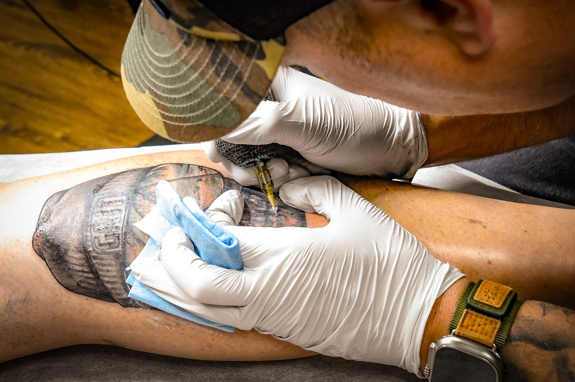 U.S. Air Force Chief Master Sgt. George Bender, 168th Aircraft Maintenance Squadron Chief, tattoos Brian Dianoski, Fairbanks resident, at Sublime Line Tattoo shop in Fairbanks, Alaska, Sept. 27, 2023.