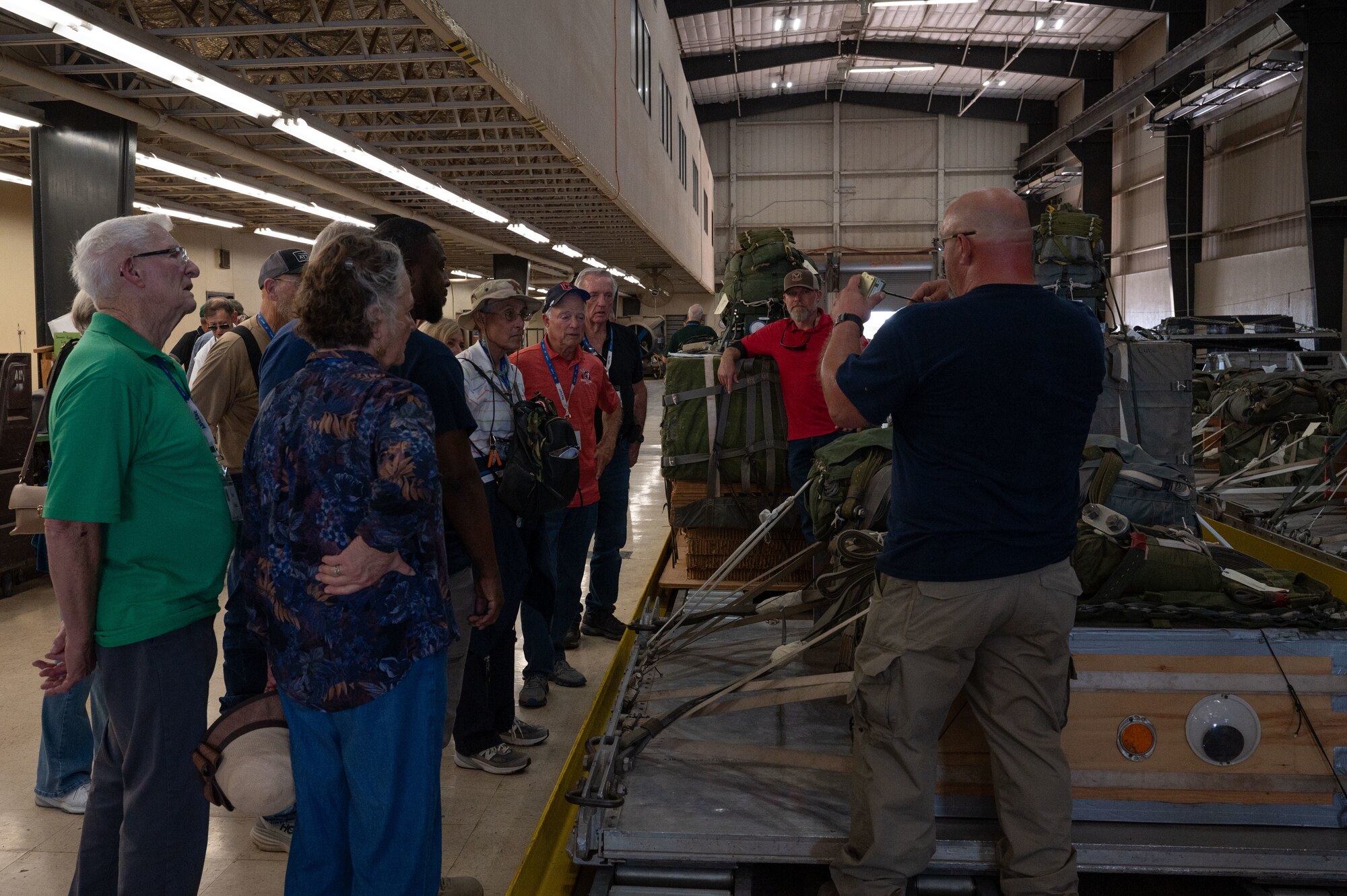 The 774th Tactical Airlift Squadron’s veterans and spouses receive a presentation about aerial delivery systems at Dyess Air Force Base, Texas, Oct. 7, 2024. Over 100 veterans attended a 774th TAS reunion, touring base facilities and seeing the technological advances the 317th Airlift Wing has made. (U.S. Air Force Photo by Airman 1st Class Emma Anderson)