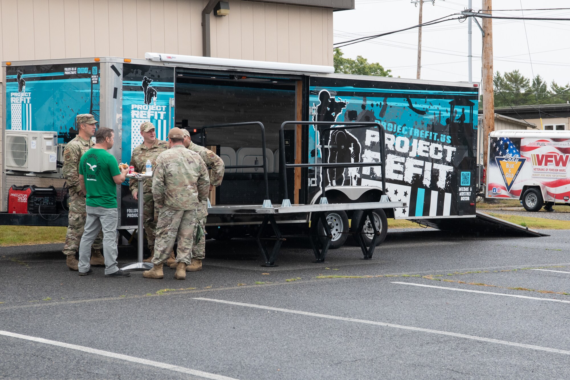 Members of the 177th Fighter Wing, New Jersey Air National Guard, stand in front of a Project Refit mobile vehicle, while attending the 177th Community Assessment and Resilience Engagement (CARE) day at the 177FW, Egg Harbor Township, New Jersey, Sept. 27, 2024. CARE day is a program in which members of the 177th FW can come together to celebrate community and new partnerships. (U.S. Air National Guard photo by Airman 1st Class Andrew Relyea)