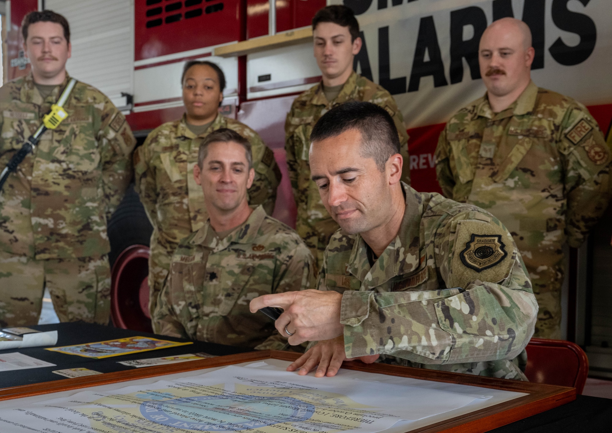 U.S. Air Force Col. Morgan Lohse, 4th Fighter Wing commander, signs the 2024 Fire Prevention Proclamation at Seymour Johnson Air Force Base, North Carolina, Oct. 1, 2024. The theme for 2024 Fire Prevention Week stresses the importance of having a functional smoke alarm to increase the chance of survival during a house fire. (U.S. Air Force photo by Airman 1st Class Rebecca Tierney)