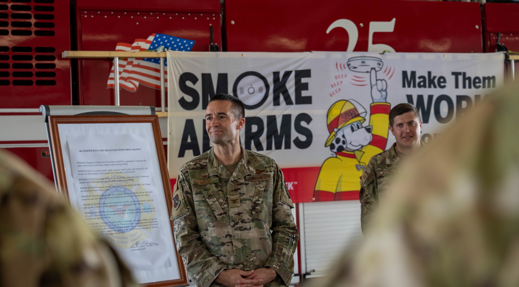 U.S. Air Force Col. Morgan Lohse, 4th Fighter Wing commander, and members of the 4th Civil Engineer Squadron fire station engage in discussion after signing the 2024 Fire Prevention Proclamation at Seymour Johnson Air Force Base, North Carolina, Oct. 1, 2024. The theme for 2024 Fire Prevention Week stresses the importance of having a functional smoke alarm to increase the chance of survival during a house fire. (U.S. Air Force photo by Airman 1st Class Rebecca Tierney)