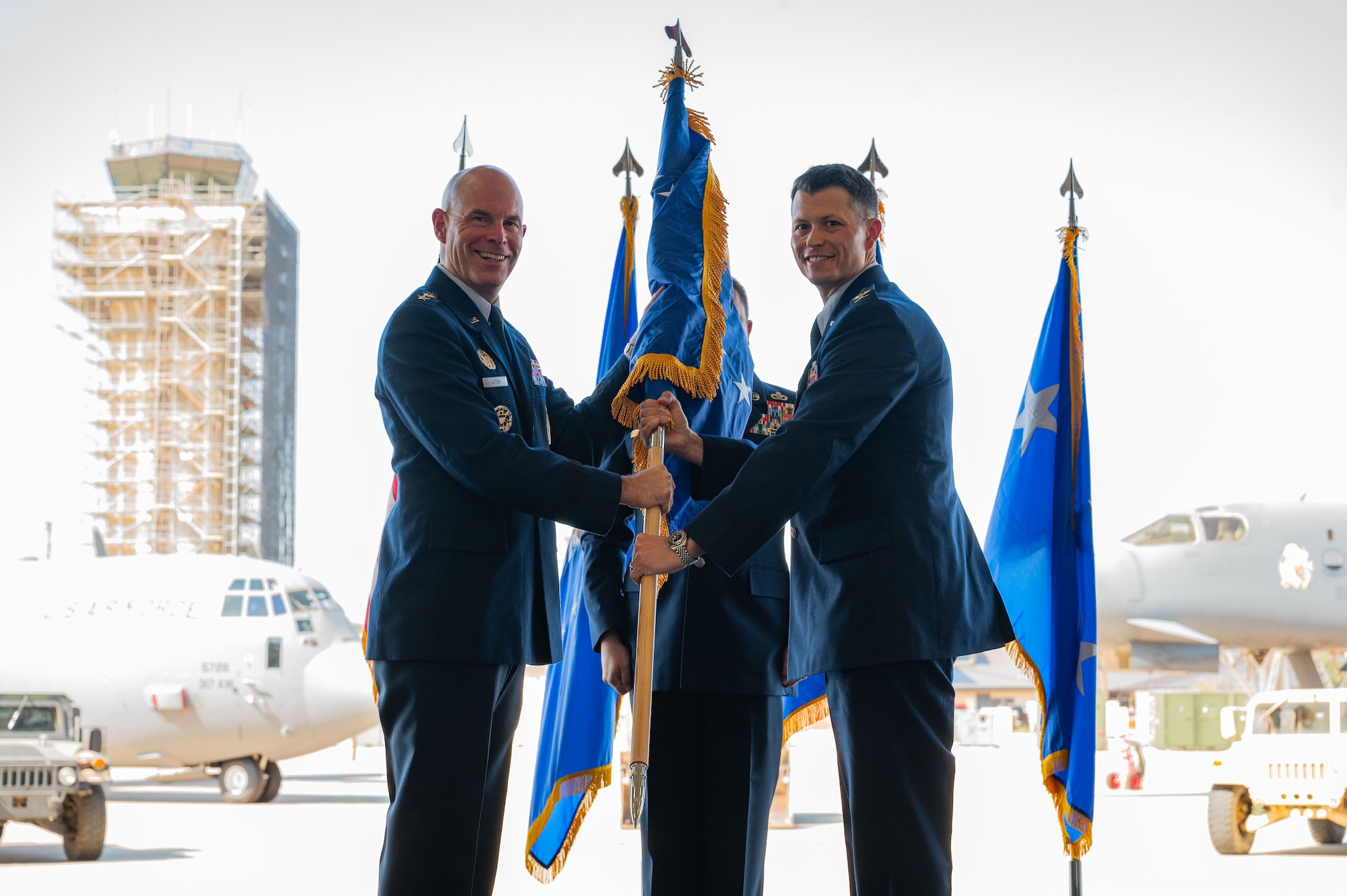 U.S. Air Force Lt. Gen. Michael Lutton, Air Force Global Strike Command deputy commander, passes the guidon to Col. Thomas Walsh, 21st Air Task Force commander, at the 21st ATF assumption of command at Dyess Air Force Base, Texas, Oct. 8, 2024. The 21st ATF will test new methods to create efficient, deployable combat wings, providing insights to guide future Air Force organization, training, and equipping strategies. (U.S. Air Force photo by Airman 1st Class Emma Anderson)