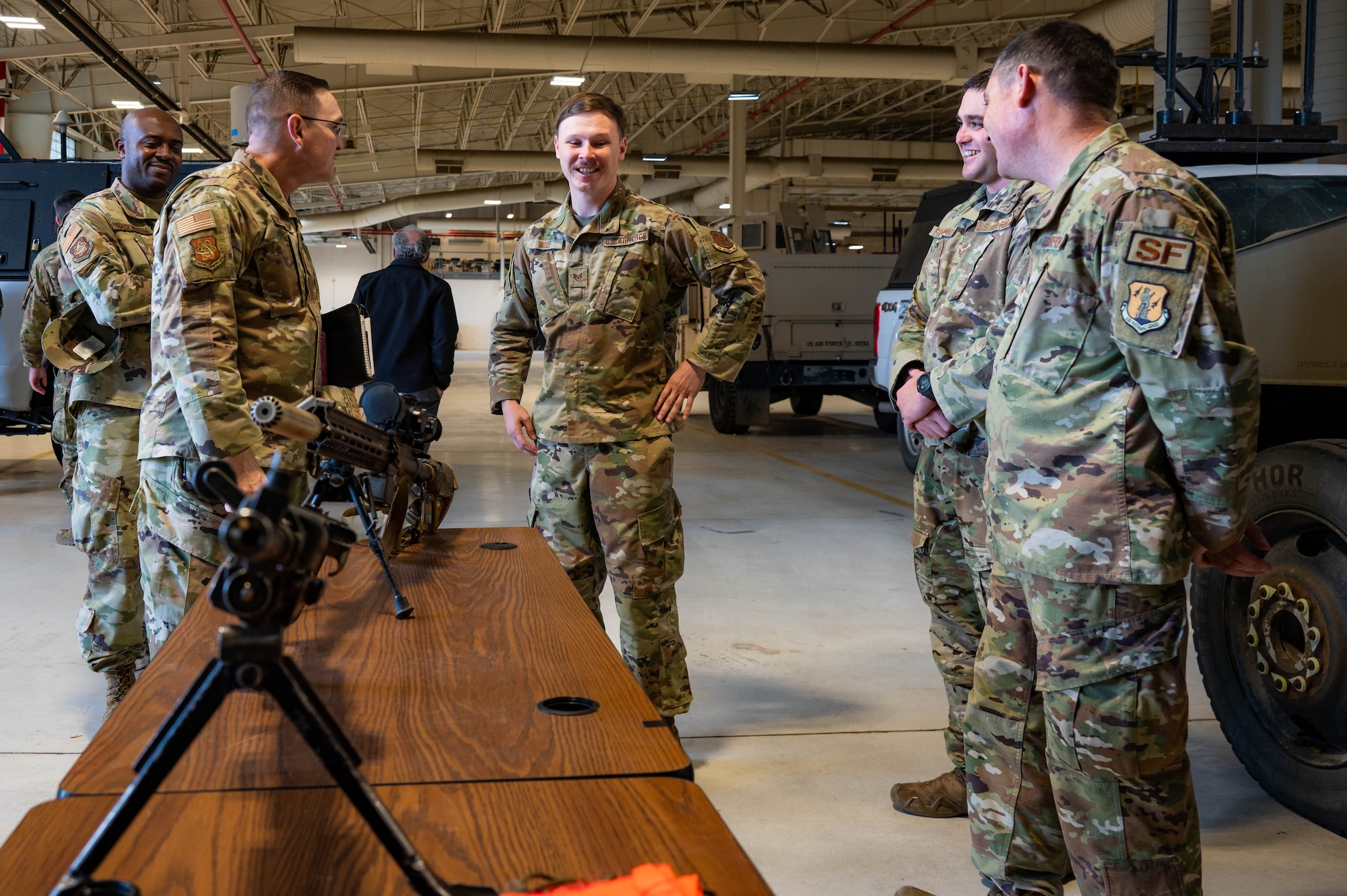 Airmen from the 91st Security Forces Group brief Chief Master Sgt. Travis Chadick, Air Force Nuclear Weapons Center command chief, on the weapon systems utilized by Security Force at Minot Air Force Base, North Dakota, Oct. 3, 2024. Chadick visited to mentor Airmen and learn Minot AFB’s unique dual nuclear wing mission firsthand. (U.S. Air Force photo by Senior Airman Alexander)