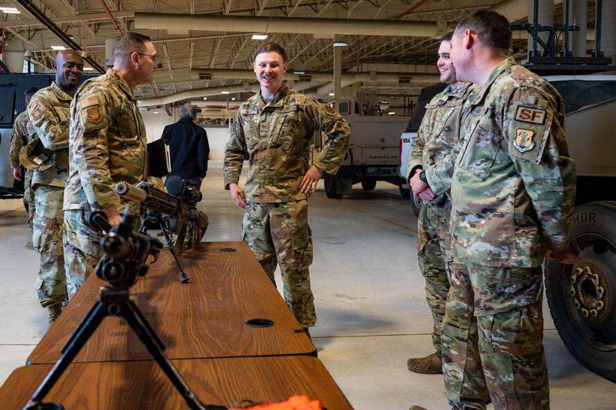 Airmen from the 91st Security Forces Group brief Chief Master Sgt. Travis Chadick, Air Force Nuclear Weapons Center command chief, on the weapon systems utilized by Security Force at Minot Air Force Base, North Dakota, Oct. 3, 2024. Chadick visited to mentor Airmen and learn Minot AFB’s unique dual nuclear wing mission firsthand. (U.S. Air Force photo by Senior Airman Alexander)