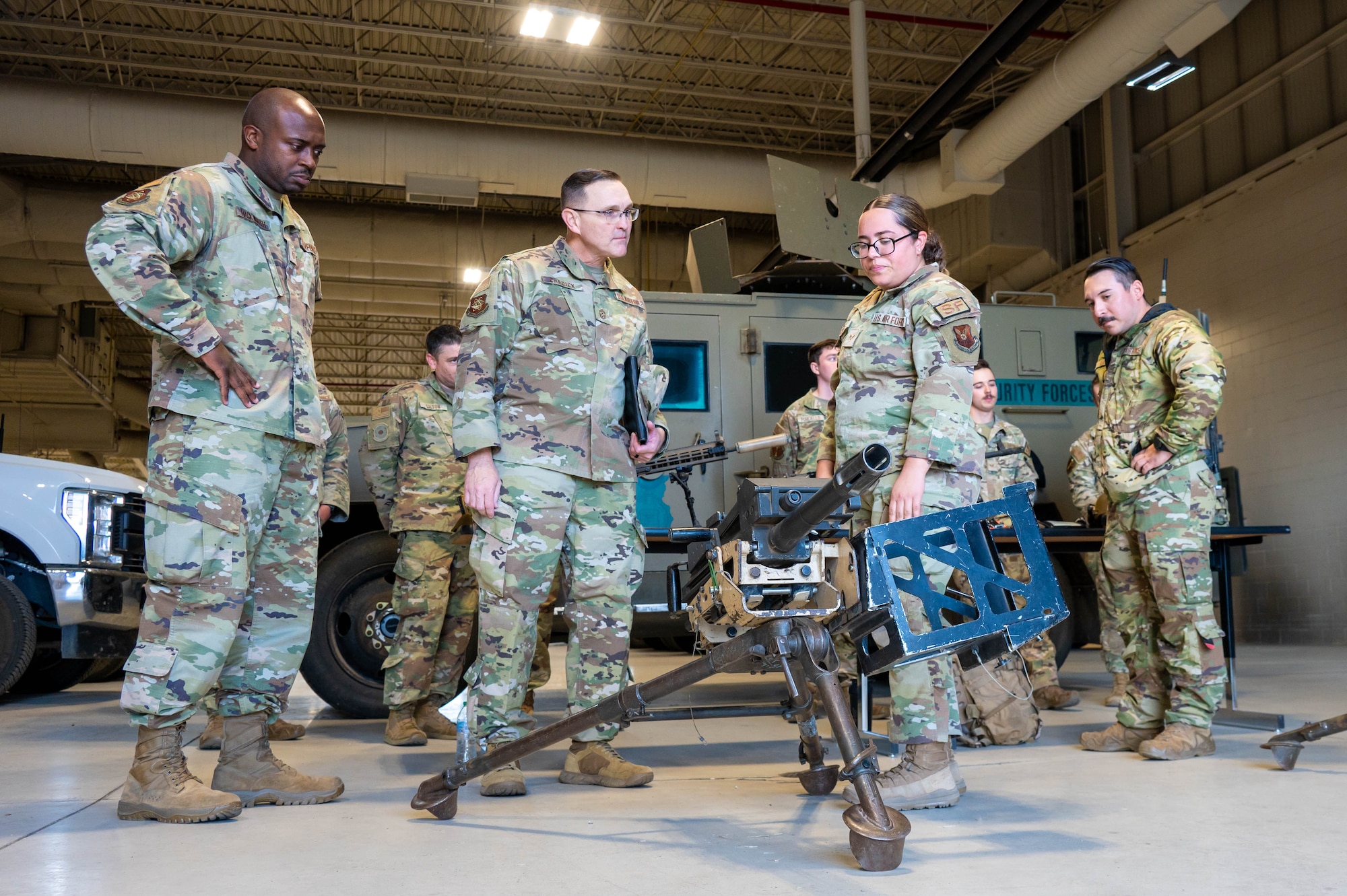 Airmen from the 91st Security Forces Group brief Chief Master Sgt. Travis Chadick, Air Force Nuclear Weapons Center command chief, on the weapon systems utilized by Security Forces at Minot Air Force Base, North Dakota, Oct. 3, 2024. Chadick visited to mentor Airmen and learn firsthand Minot AFB’s unique dual nuclear wing mission. (U.S. Air Force photo by Senior Airman Alexander)