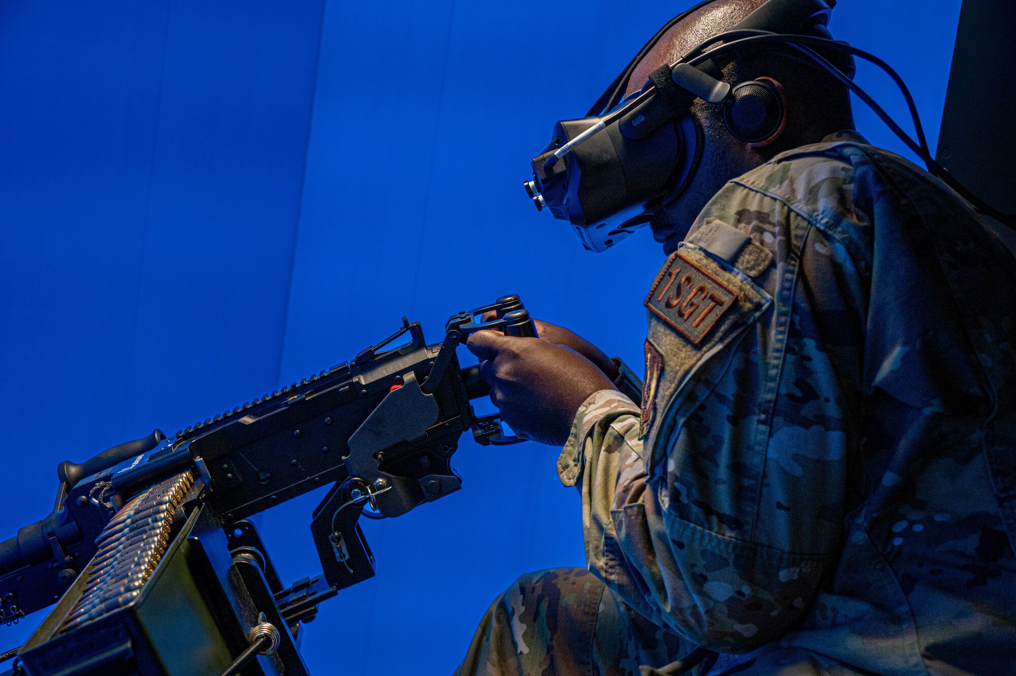 Master Sgt. Anthony Hackworth, Air Force Nuclear Weapons Center first sergeant, fires a M-240 weapon in a virtual UH-1 Iroquois simulation at Minot Air Force Base, North Dakota, Oct. 4, 2024. The virtual trainer allows Airmen to train on the M-240 more often and regularly, with no ammunition spent. (U.S. Air Force photo by Senior Airman Alexander)