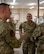 Chief Master Sgt. Travis Chadick, Air Force Nuclear Weapons Center command chief (center), listens during a briefing with Airmen from the 91st Maintenance Group at Minot Air Force Base, North Dakota, Oct. 4, 2024. The visit provided an opportunity for Chadick to discuss readiness and the vital role of maintenance personnel in supporting the nuclear deterrence mission. (U.S. Air Force photo by Airman 1st Class Luis Gomez)