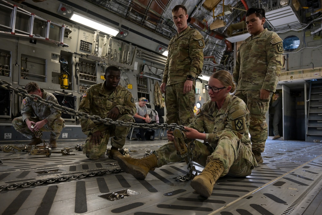 U.S. Army Sgt. 1st Class Lorraine Yarber, Bravo Battery 1st Battalion 14th Field Artillery Regiment platoon sergeant, secures cargo onto a C-17 Globemaster III aircraft at Altus Air Force Base, Oklahoma, Oct. 7, 2024. This training provided Soldiers the ability to practice for future exercises and ensure mission readiness. (U.S. Air Force photo by Airman 1st Class Lauren Torres)