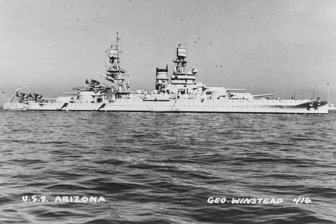 Black and white photo of a battleship in water.