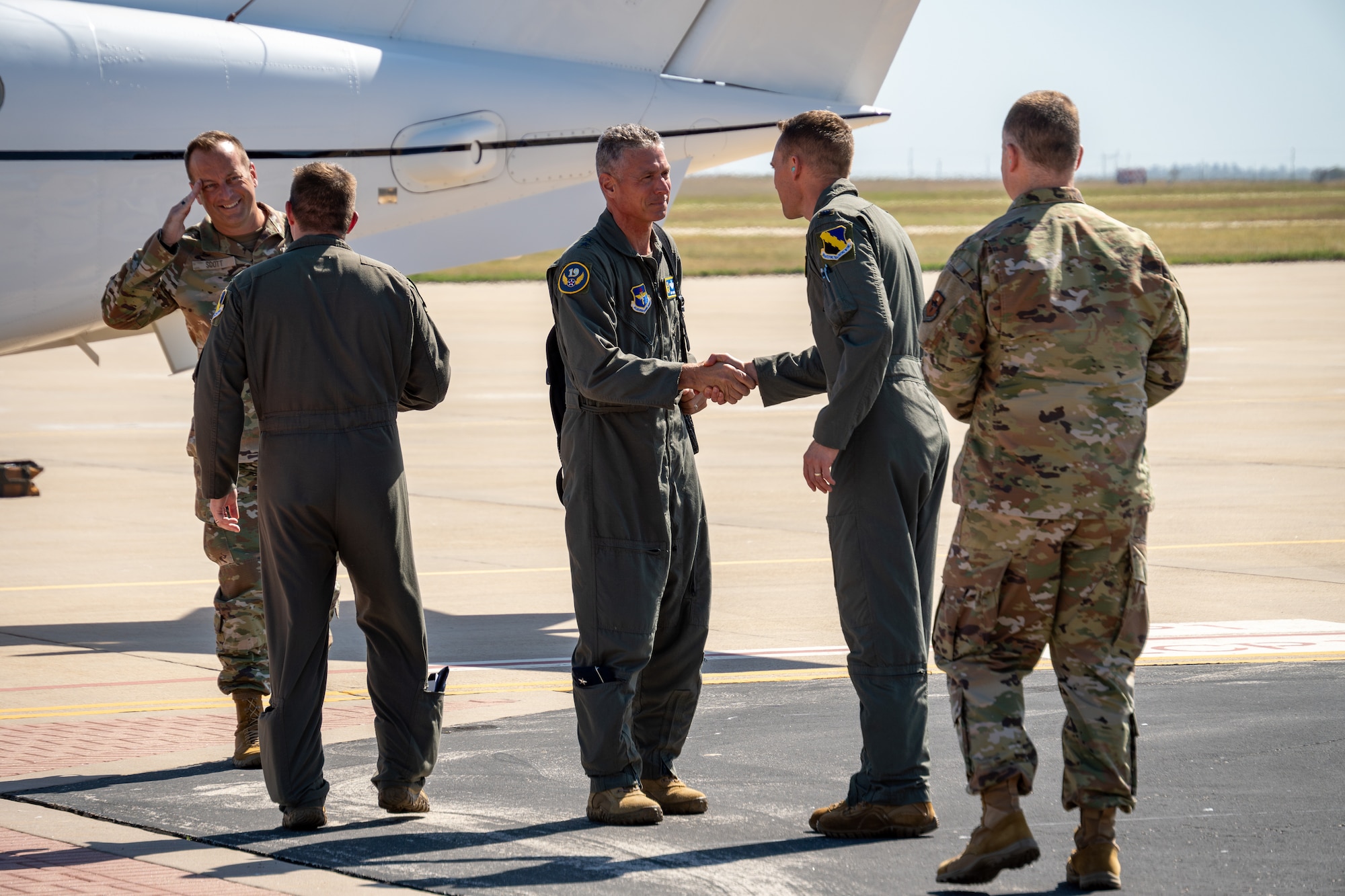 U.S. Air Force Maj. Gen. Gregory Kreuder, 19th Air Force commander, and Chief Master Sgt. Keith Scott, 19th AF command chief are greeted