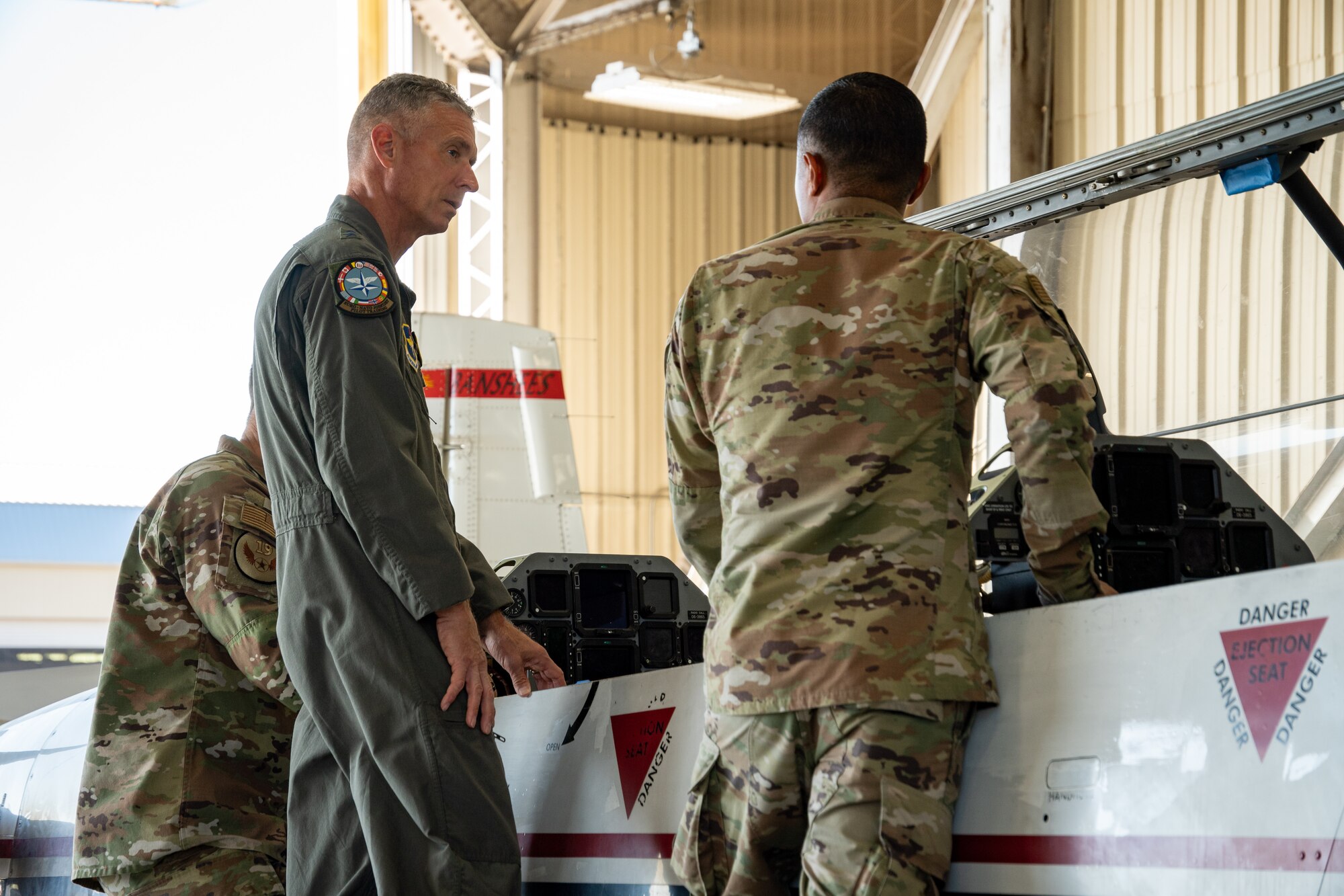 U.S. Air Force Maj. Gen. Gregory Kreuder, 19th Air Force commander, and Chief Master Sgt. Keith Scott, 19th AF command chief are briefed by Tech. Sgt. Manuel Jimenez Tlatenchi