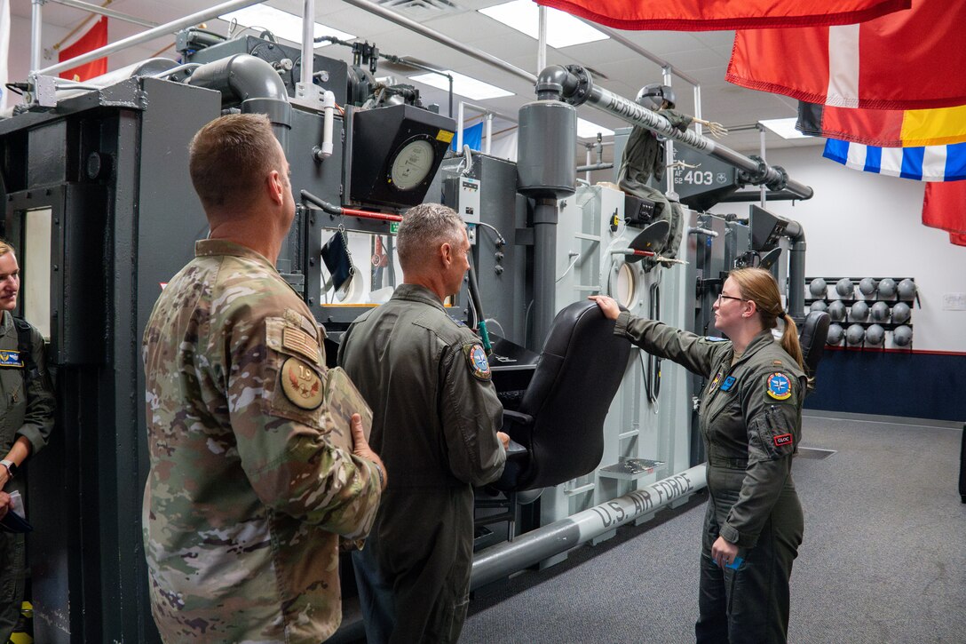 U.S. Air Force Maj. Gen. Gregory Kreuder, 19th Air Force commander, and Chief Master Sgt. Keith Scott, 19th AF command chief are briefed by 2nd Lt. Mallory Desautels