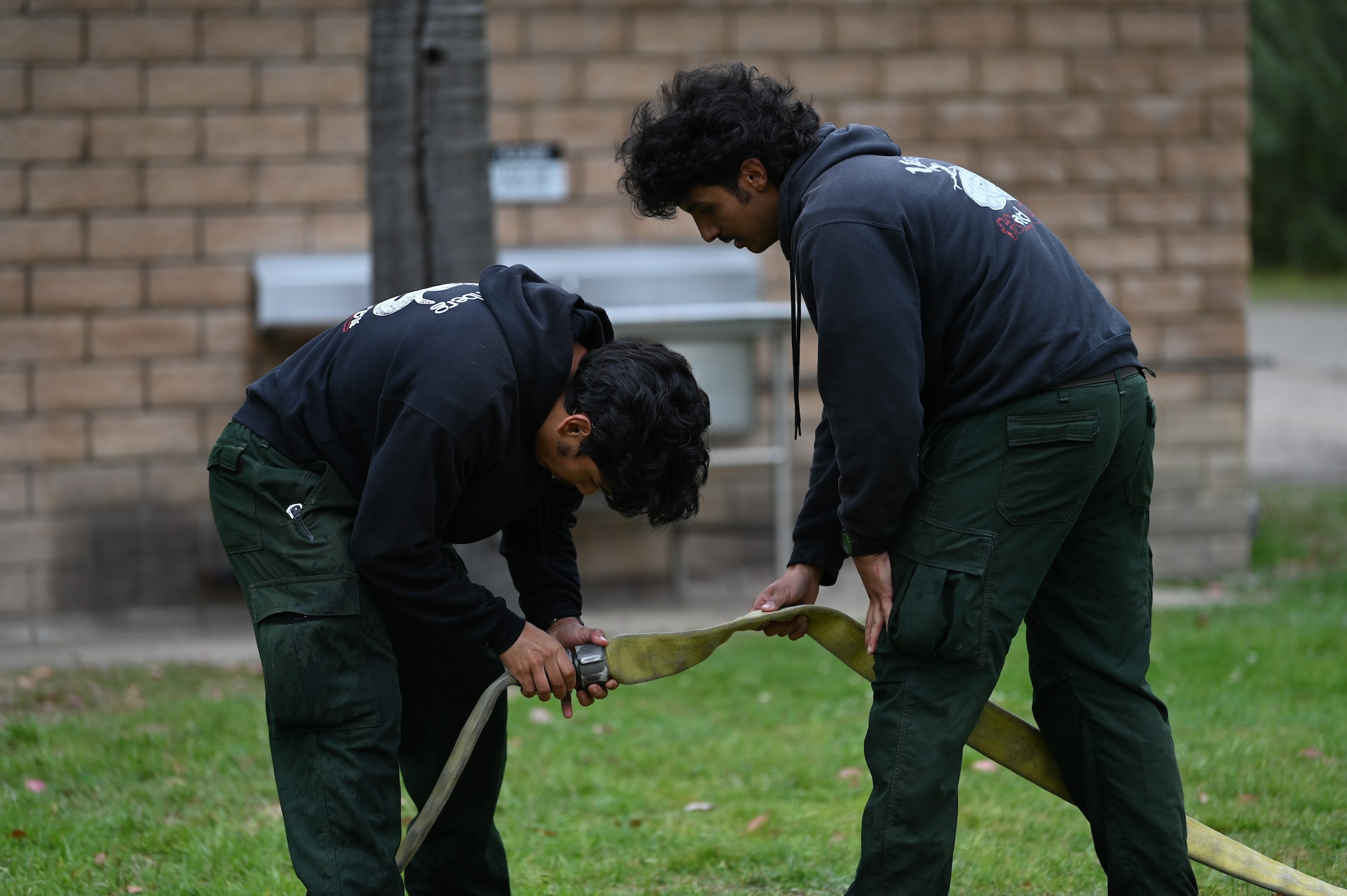 vandenberg base members participate in many events during a fire muster competition, events including pulling a truck, a water bucket challenge,