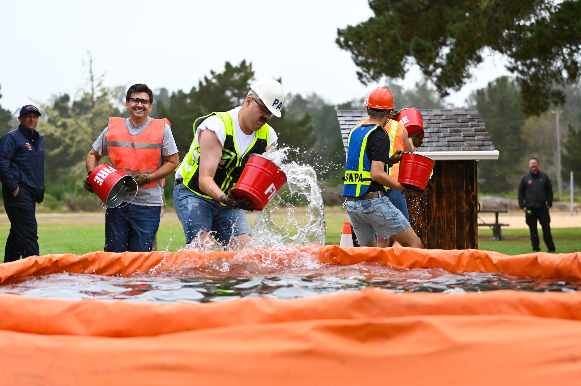 vandenberg base members participate in many events during a fire muster competition, events including pulling a truck, a water bucket challenge,