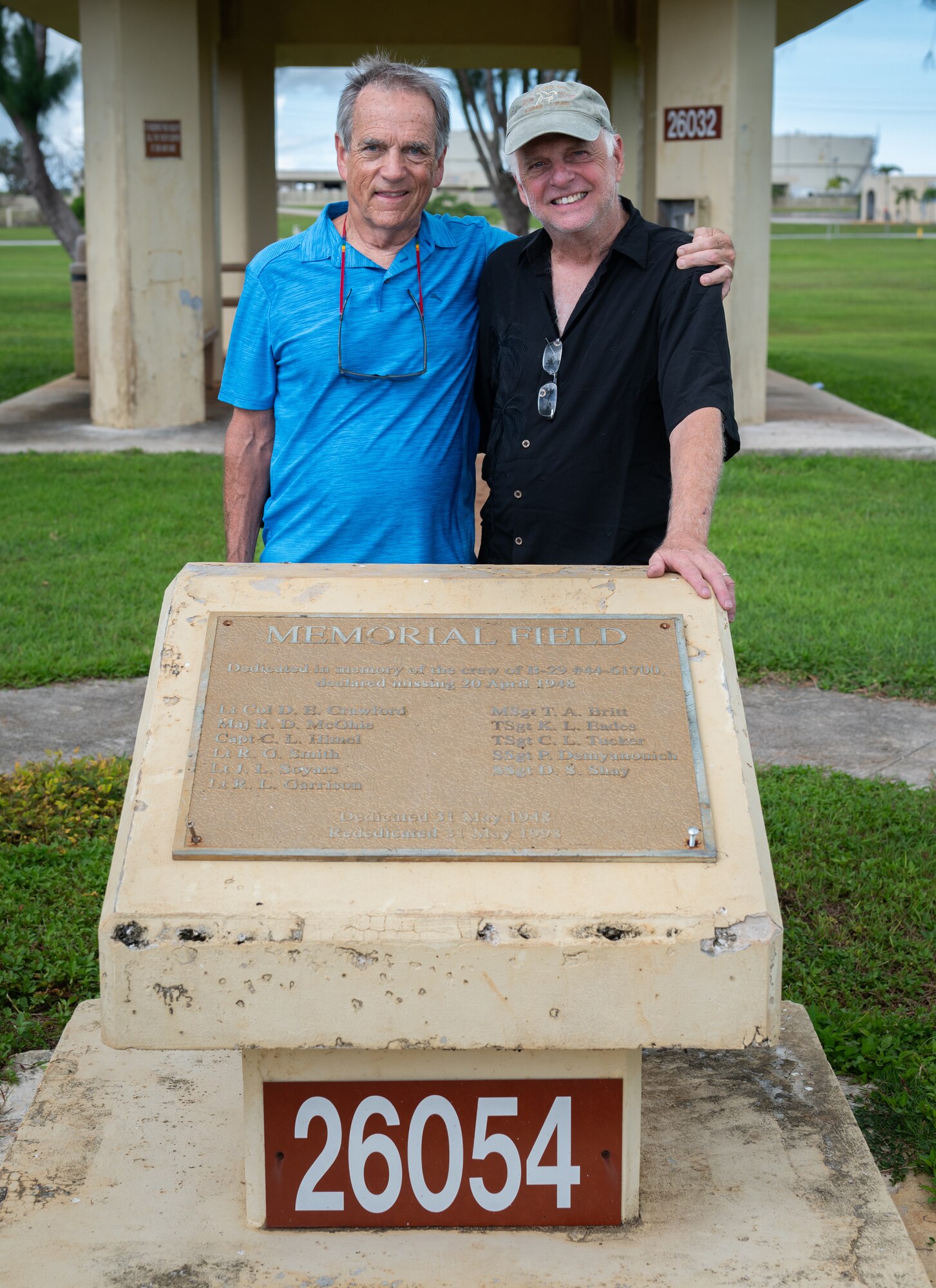 Jeff Richard McGhie, left, and his brother Kevin Wright pose for a photo with a plaque listing the names of B-29 #44-61700 crew members at the Memorial Field on Andersen Air Force Base, Guam, August 26, 2024. Jeff McGhie's father, Richard McGhie Jr., was the co-pilot of B-29 #44-61700. During a training flight the B-29 went missing. Jeff was only a year old at the time. 77 years later, Jeff finally made it to Guam to see the Memorial that was dedicated to his father and crew following the tragic incident. (U.S. Air Force photo by Staff Sgt. Pedro Tenorio)