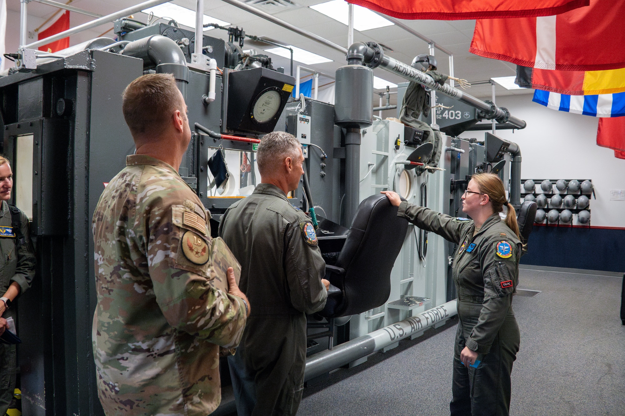 U.S. Air Force Maj. Gen. Gregory Kreuder, 19th Air Force commander, and Chief Master Sgt. Keith Scott, 19th AF command chief are briefed by 2nd Lt. Mallory Desautels