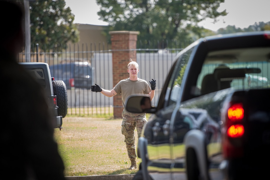 A member of the 123rd Logistics Readiness Squadron directs vehicle traffic during a Readiness Exercise Validation inspection at the Kentucky Air National Guard Base in Louisville, Ky., Aug. 23, 2024. The multi-day exercise tested the wing’s ability to operate in a degraded environment. (U.S. Air National Guard photo by Airman 1st Class Annaliese Billings)