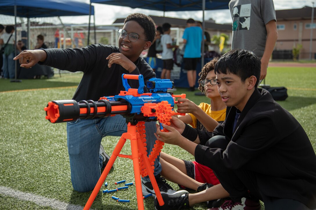 Children shoot a toy gun at a target on Marine Corps Air Station Iwakuni, September 20, 2024. Health-A-Palooza is an annual event on MCAS Iwakuni that aims to inform service members and their families about the health and fitness opportunities that are available to them on base. (U.S. Marine Corps photo by Sgt. Randall Whiteman)