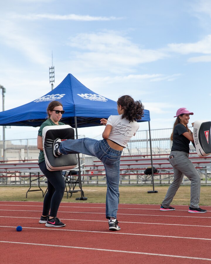 Dominique Van den Bruel, a Dutch kickboxing demonstrator, left, teaches children on Marine Corps Air Station Iwakuni kick boxing, at MCAS Iwakuni, Japan, September 20, 2024. Health-A-Palooza is an annual event on MCAS Iwakuni that aims to inform service members and their families about the health and fitness opportunities that are available to them on base. (U.S. Marine Corps photo by Cpl. Brian Long)